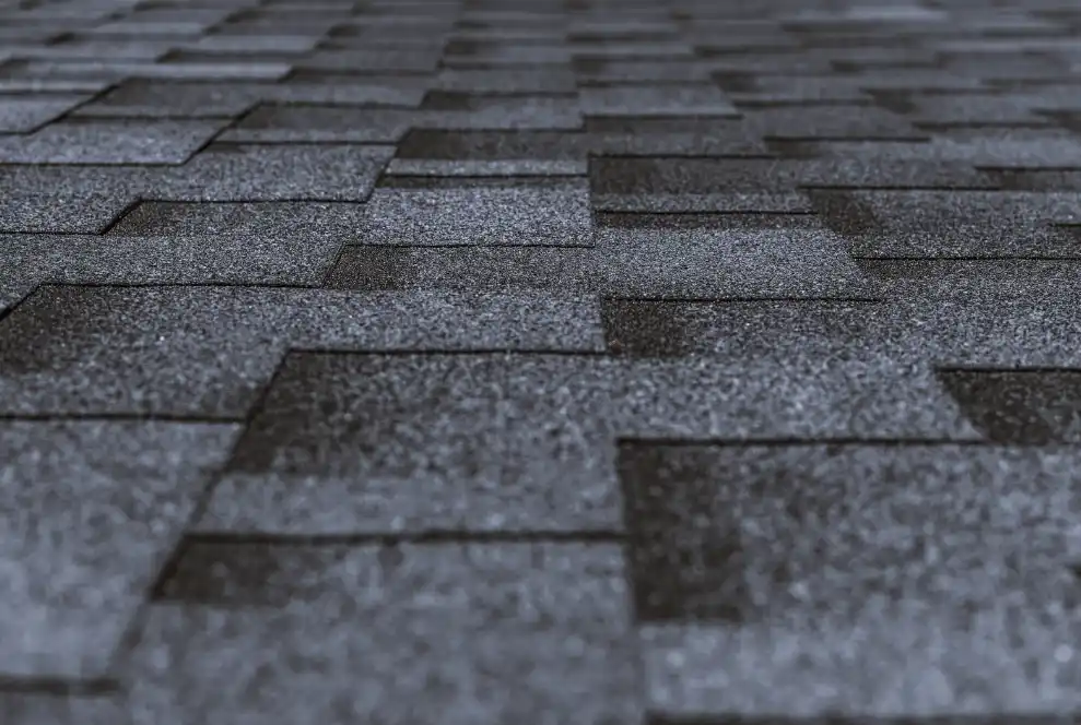 Closeup of asphalt shingle roof installation by asphalt roofing contractor in the DMV area