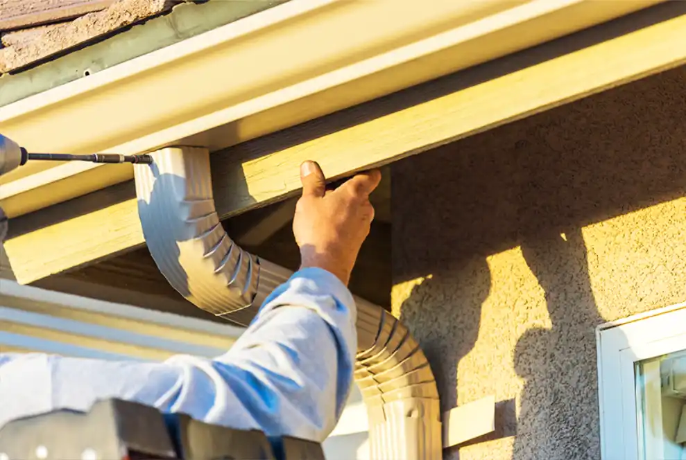 Gutter services professional installing gutter system in the DMV area