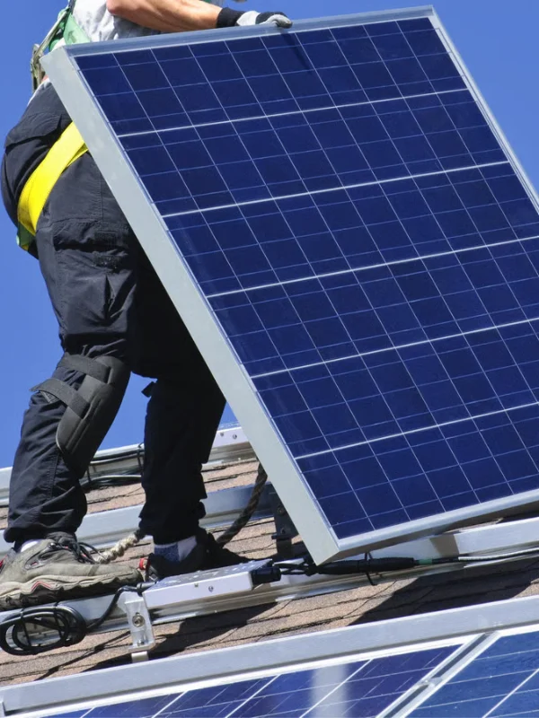 Solar panel installation technician installing panels for residential property by solar panel services contractor