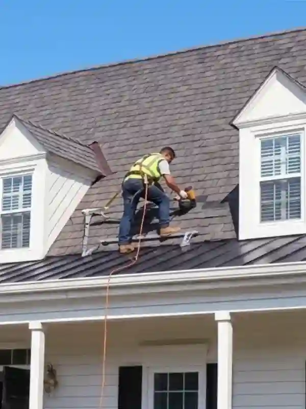Residential roofing repair contractor finishing a project in the DMV